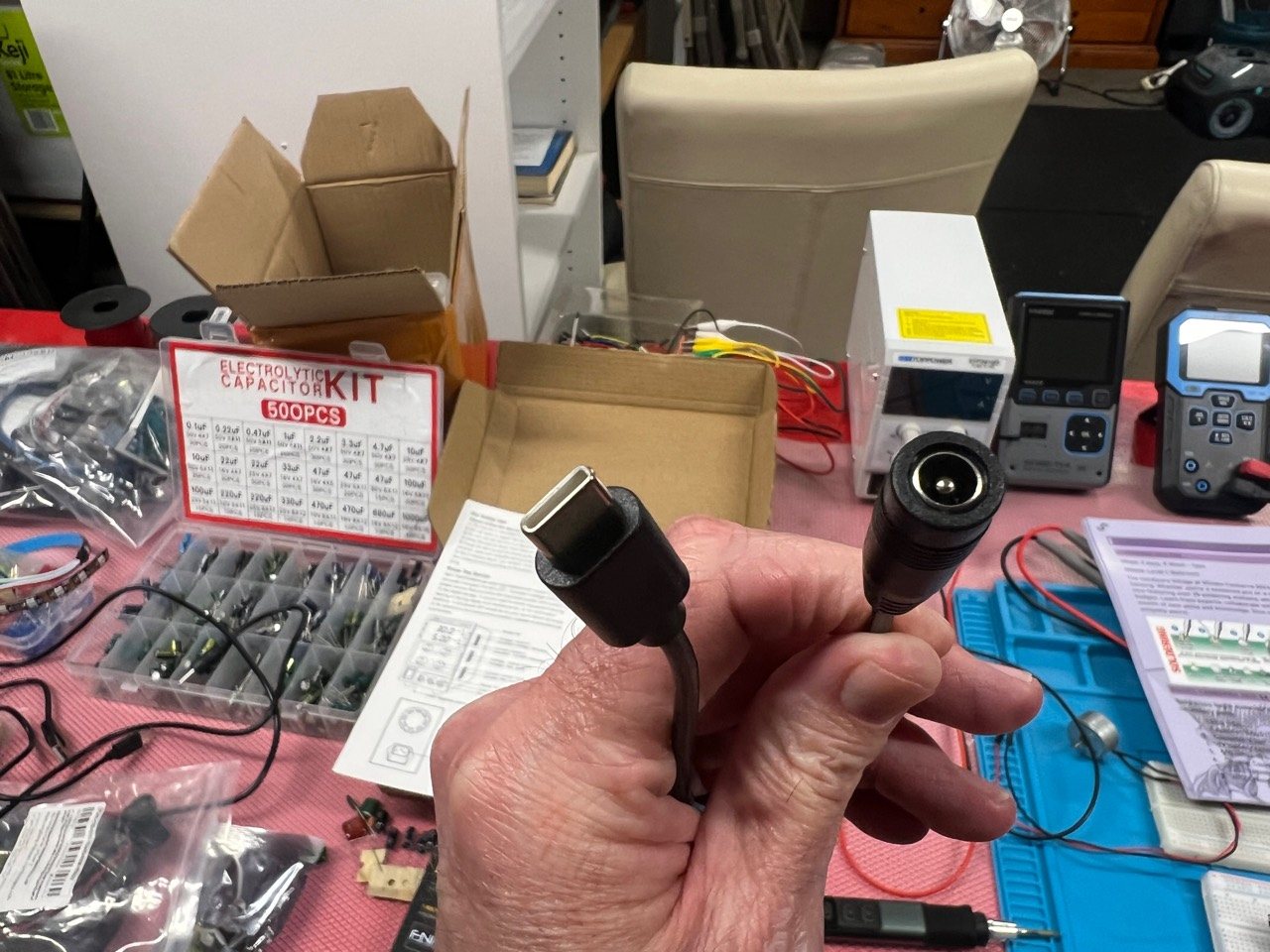 The supplied barrel-to-USB-C adapter used to feed direct DC into the soldering iron