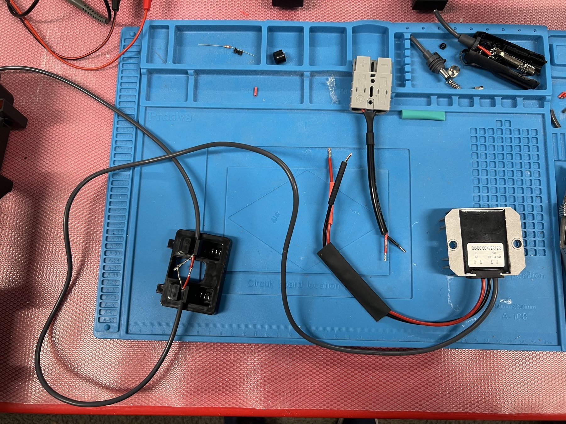 The 12 V-to-30 V boost converter, Starlink cable and Anderson-style connector laid out before assembly