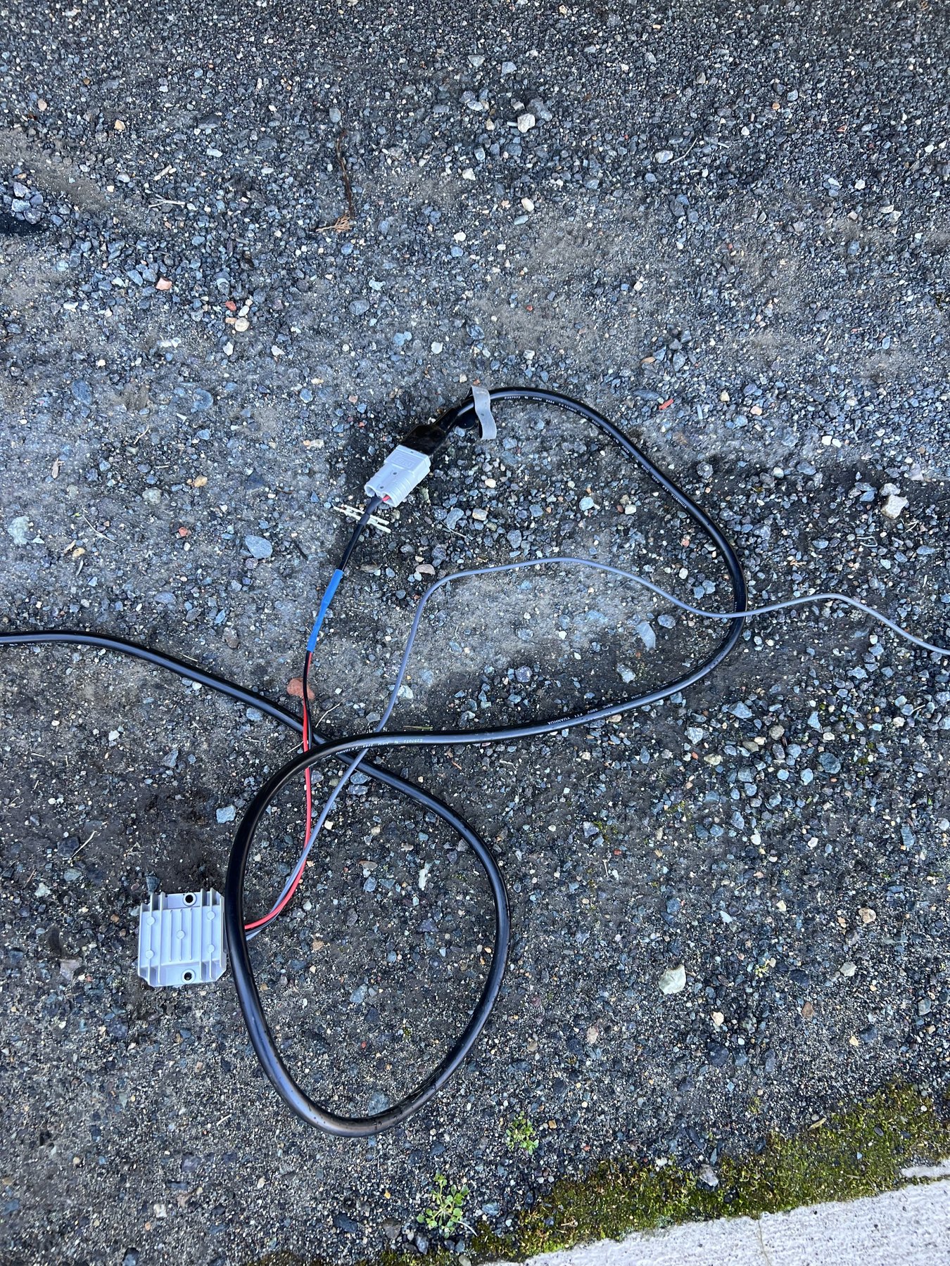 The finished Starlink Mini power cable and boost converter in a modified plastic weather-protection enclosure beside the caravan