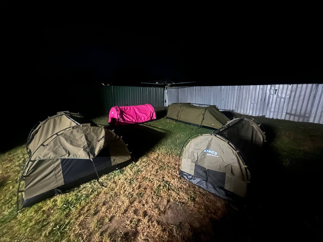 Swags set up on the back lawn at night