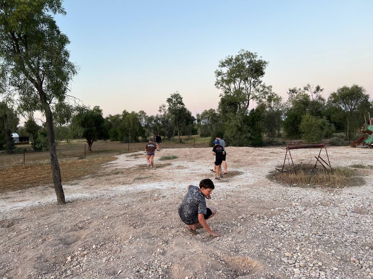 Crouched over the gravel at dusk, hunting for opals