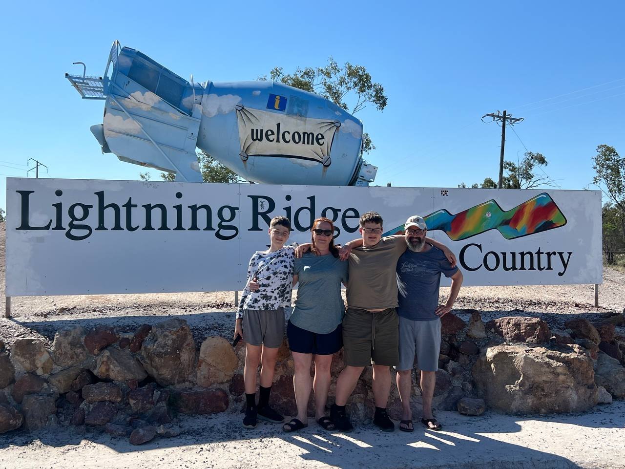 The four of us in front of the Lightning Ridge welcome sign