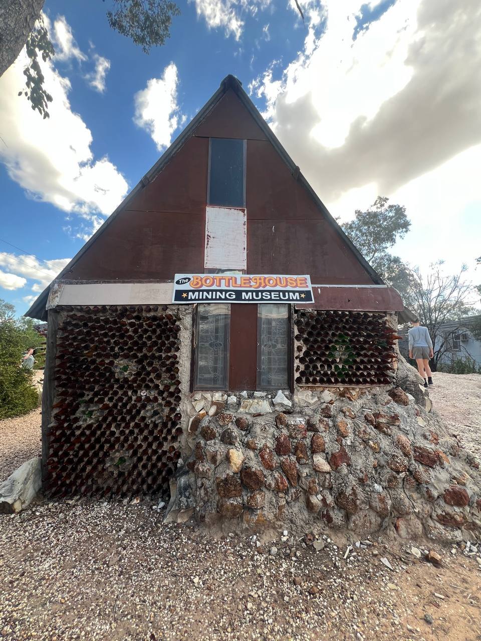 The front of the Bottle House Mining Museum, its walls built from glass bottles set in mortar