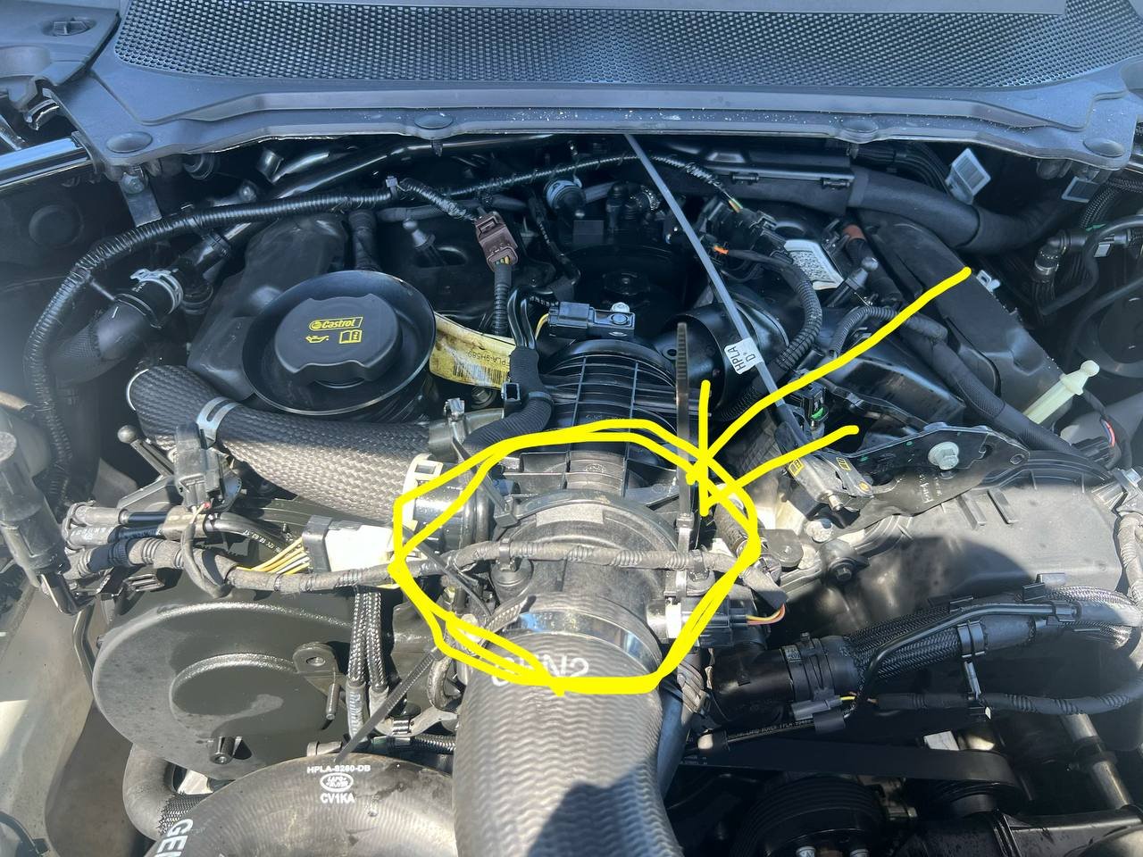 The intercooler hose junction on the Range Rover, circled in yellow marker